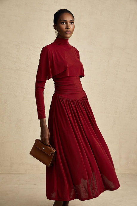 A red midi dress with ruched detailing and a flap design named Camille