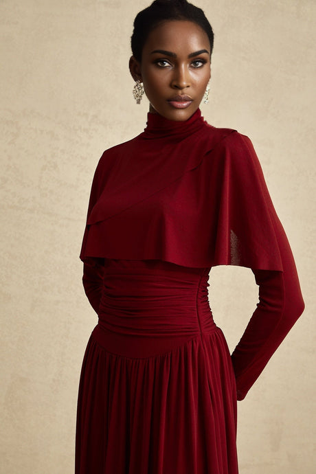 A red midi dress with ruched detailing and a flap design named Camille