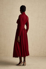 A red midi dress with ruching and a flap design named Camille featuring a flattering silhouette and elegant style