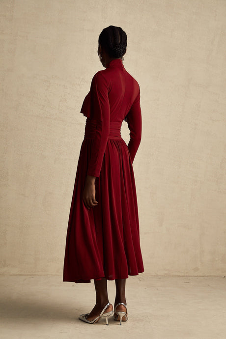 A red midi dress with ruching and a flap design named Camille featuring a flattering silhouette and elegant style