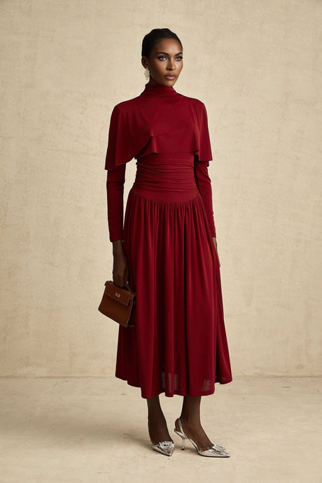 A red midi dress with ruching and a flap design named Camille