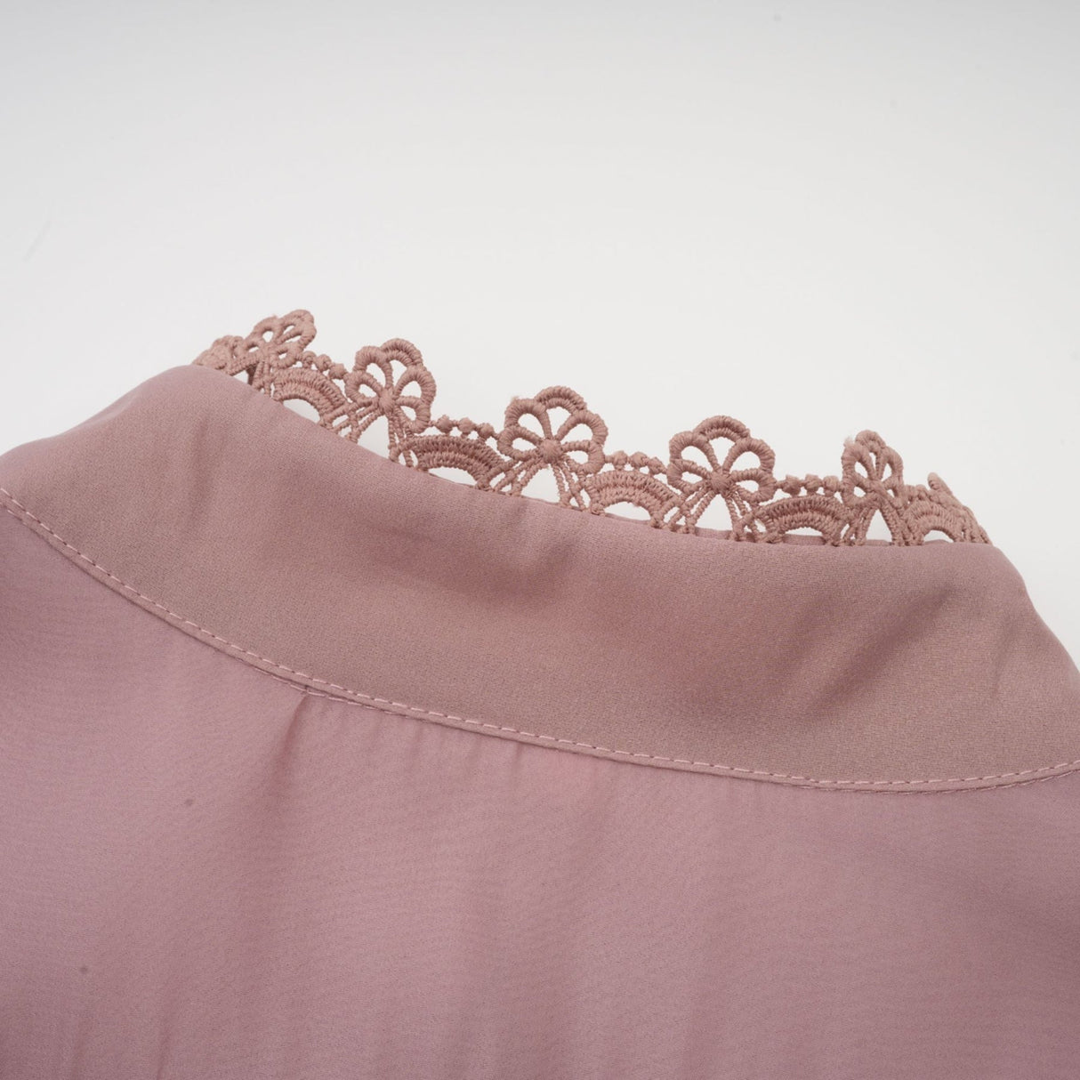 A tiered midi dress with lace detailing and cut out sections featuring a feminine and elegant design
