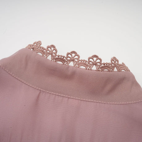 A tiered midi dress with lace detailing and cut out sections featuring a feminine and elegant design