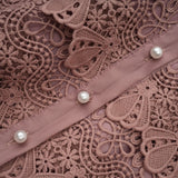 A tiered midi dress with lace detailing and cut out sections featuring a feminine silhouette and delicate design