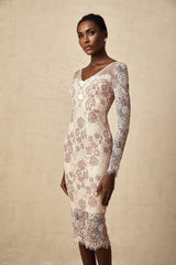 A white fitted midi dress with intricate guipure lace pattern and sheer sleeves on a female model