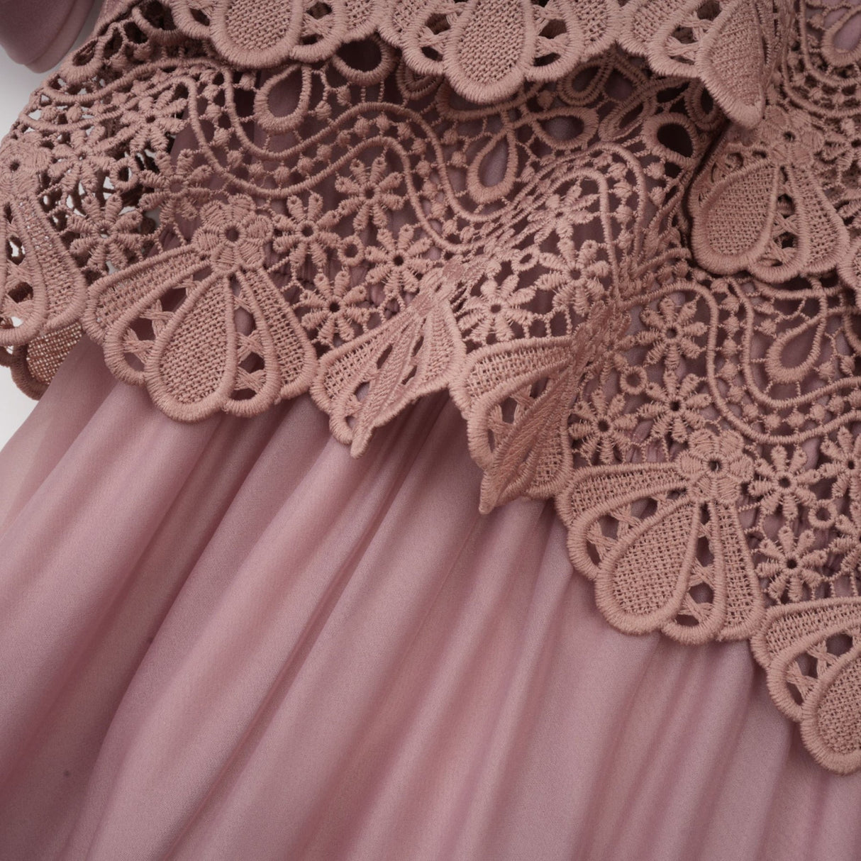 A white lace midi dress with tiered skirt and cutout details featuring a feminine silhouette and delicate floral lace pattern
