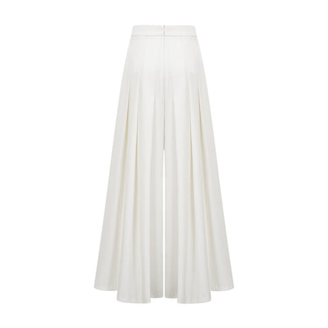A white matching set featuring a creased top and trousers worn by a model standing against a plain background