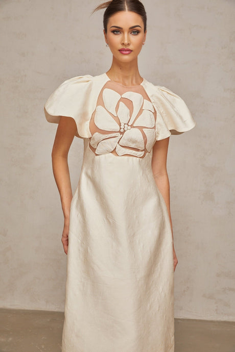 A white midi dress with a floral jacquard pattern featuring a feminine silhouette and delicate flower design throughout the fabric