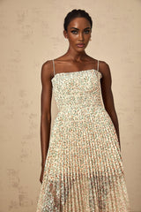 A white midi dress with a floral print pattern featuring pleated details and a Marion design