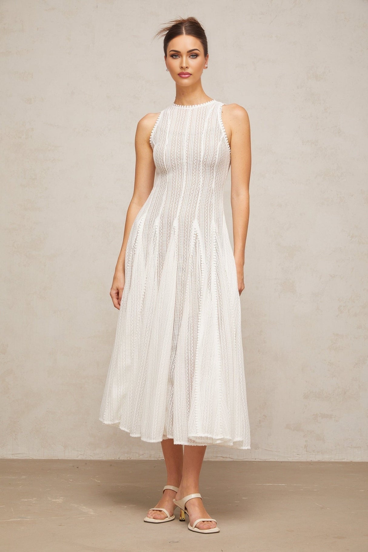A white midi dress with pointelle detailing and puff sleeves named Helene