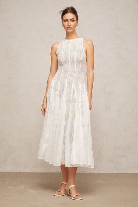 A white midi dress with pointelle detailing and puff sleeves named Helene