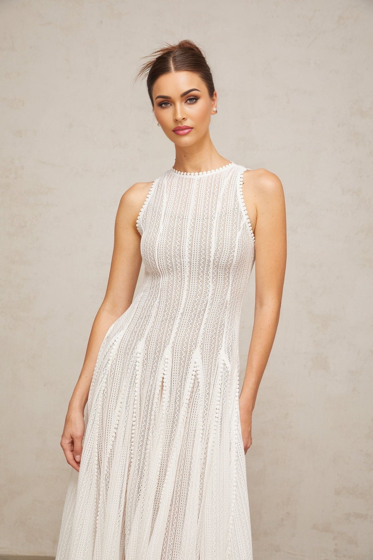 A white midi dress with puff sleeves and a pointelle knit pattern named Helene