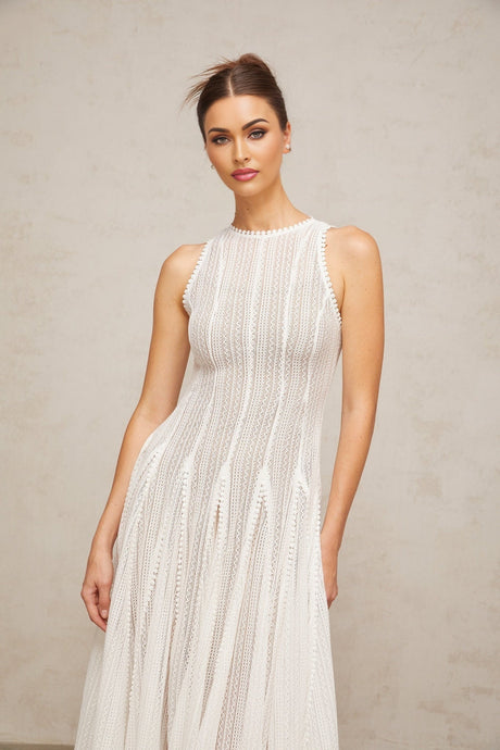 A white midi dress with puff sleeves and a pointelle knit pattern named Helene