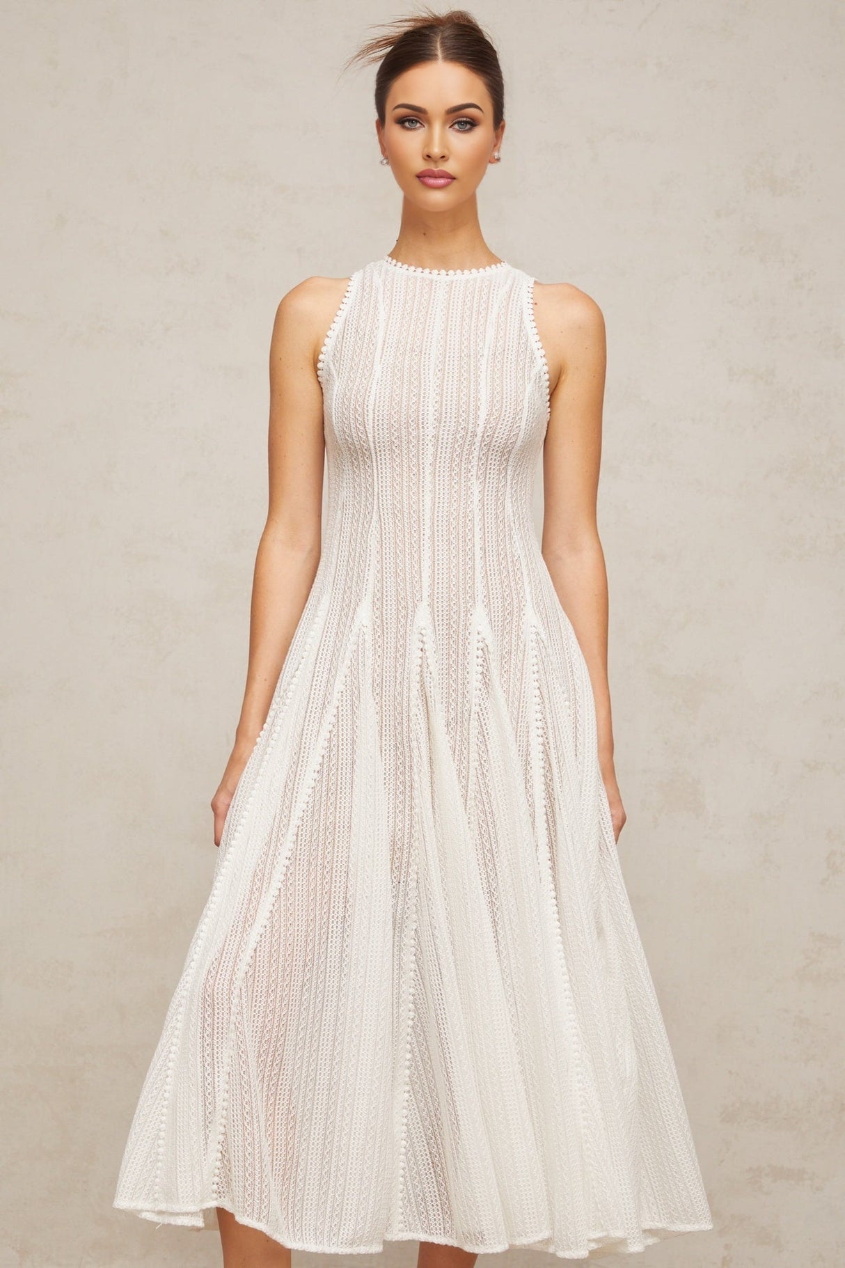 A white midi dress with puff sleeves and pointelle detailing named Helene