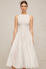 A white midi dress with puff sleeves and pointelle detailing named Helene