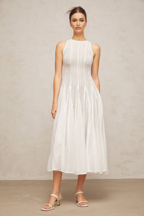 A white midi dress with puff sleeves and pointelle knit detailing named Helene
