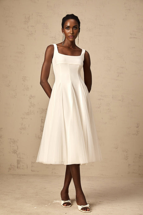 A white midi dress with tulle godet inserts named Danielle featuring a fitted bodice and flared skirt