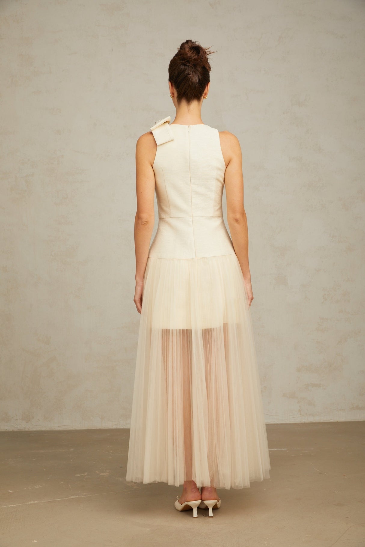 A white midi dress with tulle panels and a bow detail named Therese