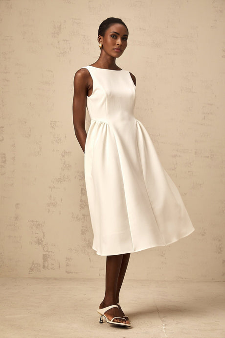 A white sleeveless midi dress with a full skirt named Yolanda