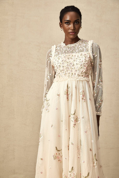 A white tulle midi dress with delicate floral embroidery featuring a Celine design with a fitted bodice and flowing skirt