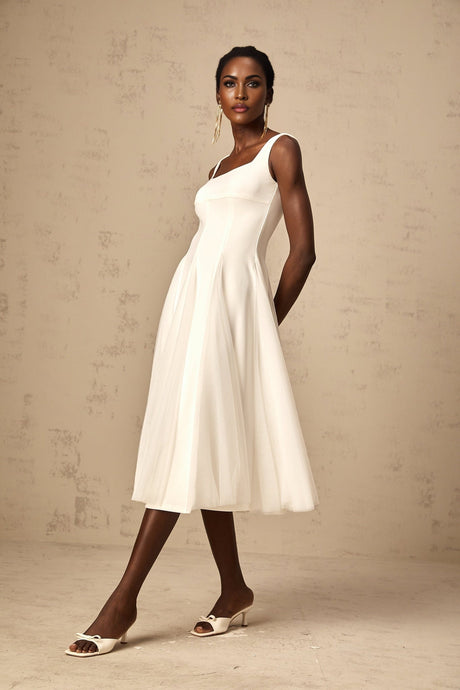 A white tulle midi dress with godet inserts featuring a fitted bodice and flared skirt named Danielle