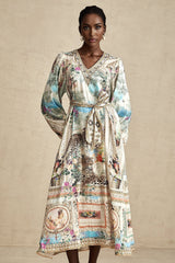 A woman wearing a belted midi dress with a V neckline in a stylish and elegant pose