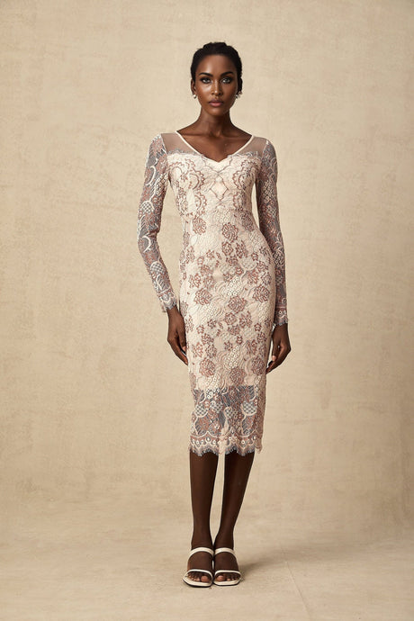 A woman wearing a fitted midi dress made of Anna guipure lace standing in an elegant pose