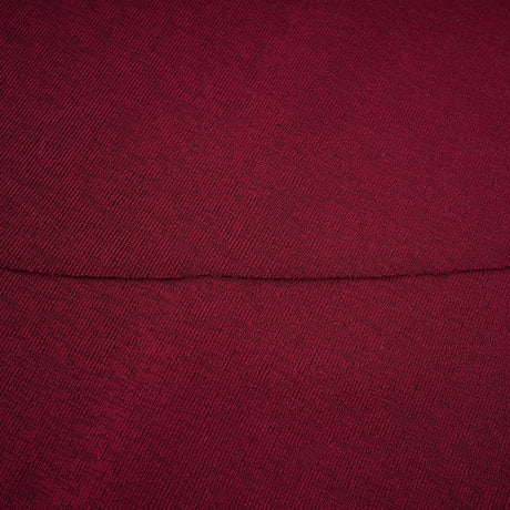 A woman wearing a red midi dress with ruched detailing and a flap design on the front