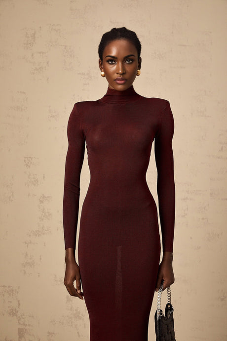 A woman wearing a red semisheer knitted midi dress with a fitted silhouette and long sleeves