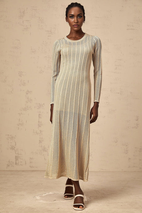 A woman wearing a sleek khaki colored fitted knit midi dress standing in a neutral setting