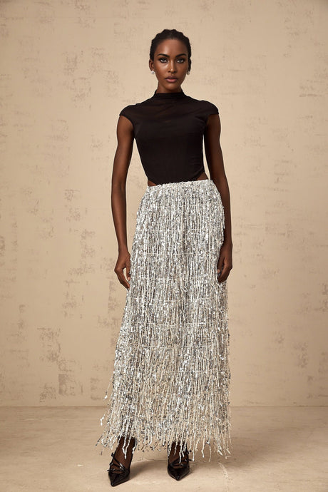 A woman wearing a twotone matching set consisting of a corsetstyle top and skirt in the Virginie style The top is fitted with a structured bodice while the skirt complements the look with a coordinating color and design