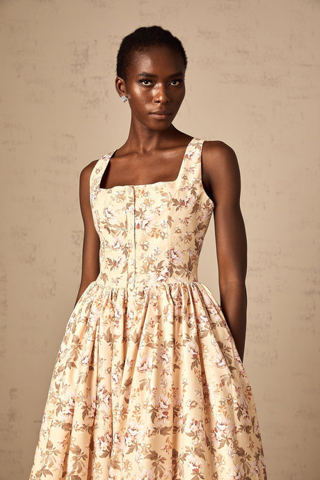 A yellow midi dress with a floral print pattern and button details