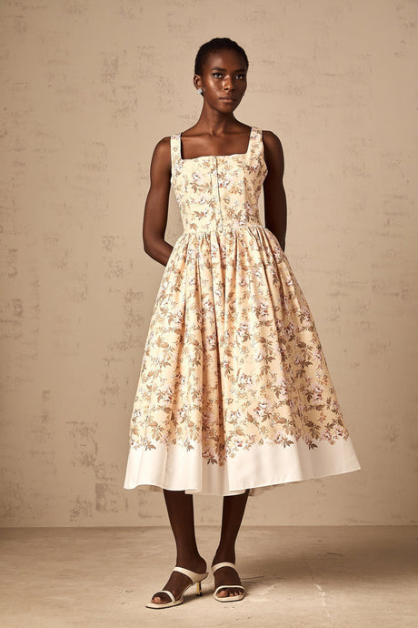 A yellow midi dress with a floral print pattern and button details