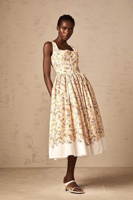 A yellow midi dress with a floral print pattern and buttons down the front