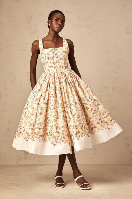 A yellow midi dress with a floral print pattern and buttons down the front