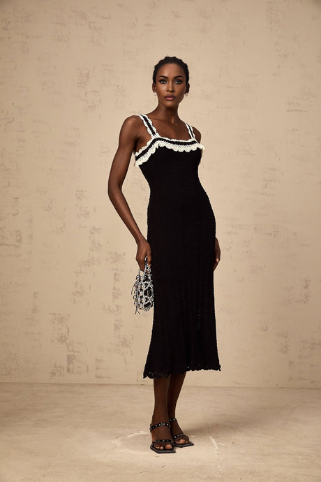 Black sleeveless crochet knit midi dress on a white background