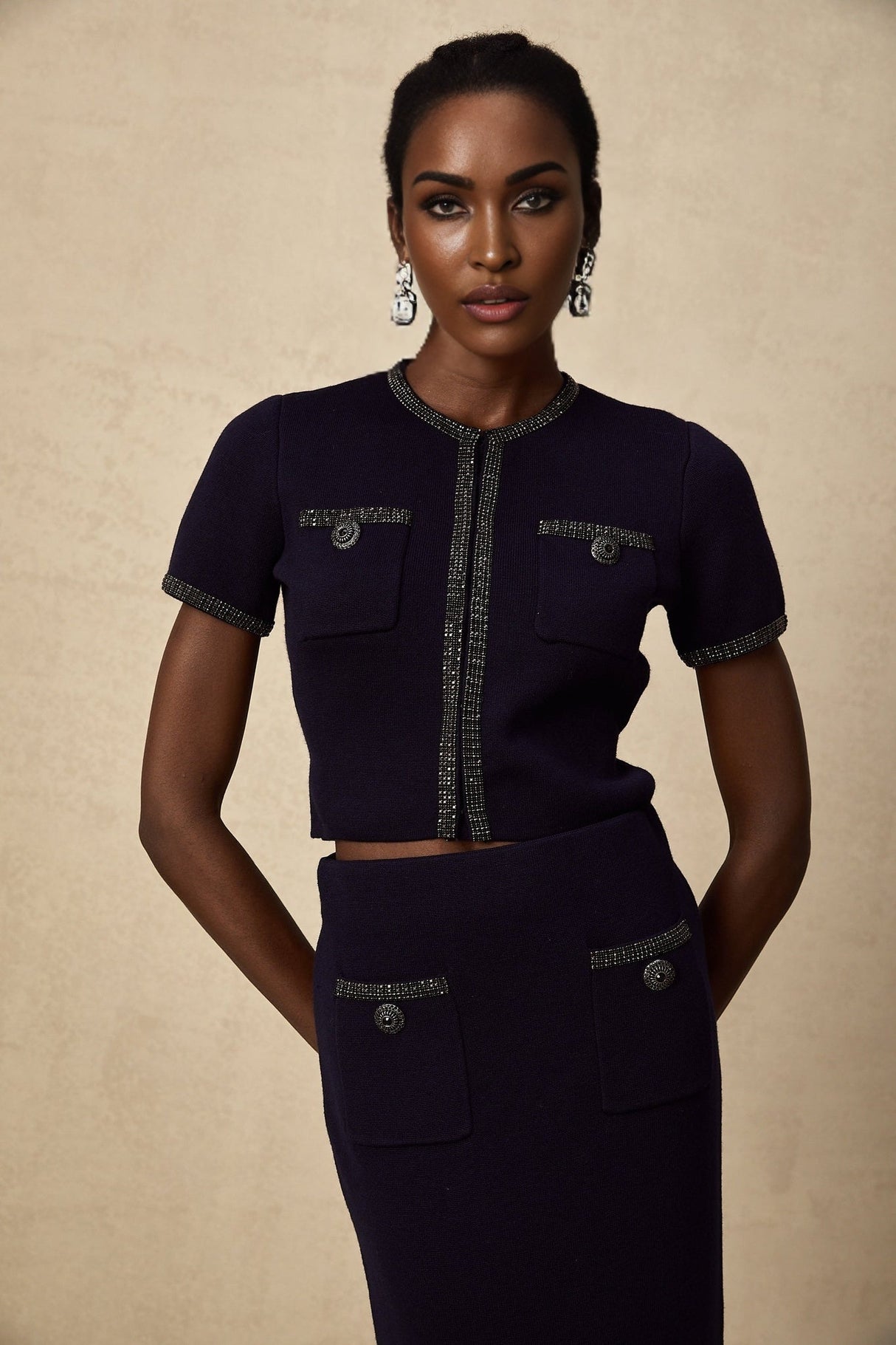 Heres a simple alt text for the product image based on the given title

Woman wearing matching ribbed knit top and skirt set with embellishments in Aida style