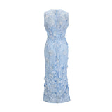 Herta blue dress with floral appliques reaching mid calf length on model against plain background