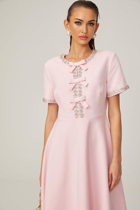 Pink midi dress with crystal accents and bow detail featuring Cassiopeia design