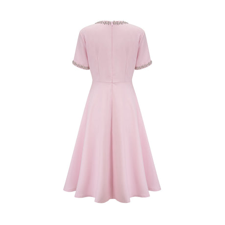 Pink midi dress with crystal accents and bow detail named Cassiopeia