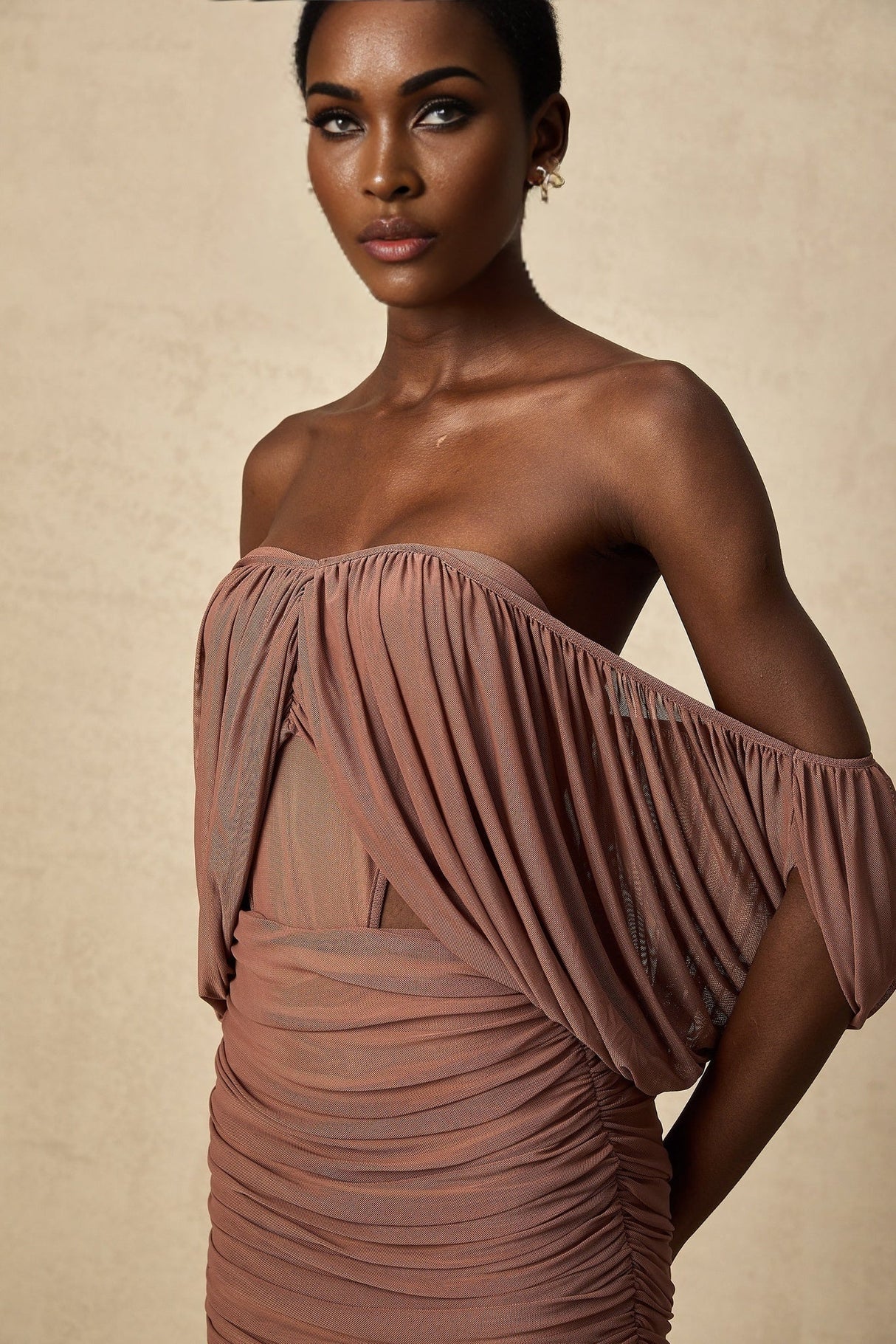 Two piece matching set featuring an offshoulder bodysuit and skirt in Zohra style