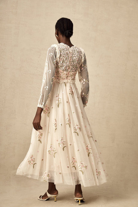 White tulle midi dress with delicate floral embroidery featuring long sleeves and a high neckline from Celine