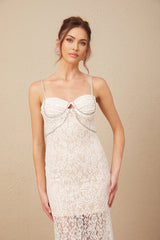 Woman wearing a black lace midi dress with crystal embellished bustier top and fitted silhouette