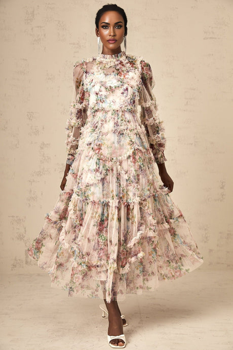 Woman wearing a floral patterned midi dress with ruffled tulle details and a feminine silhouette