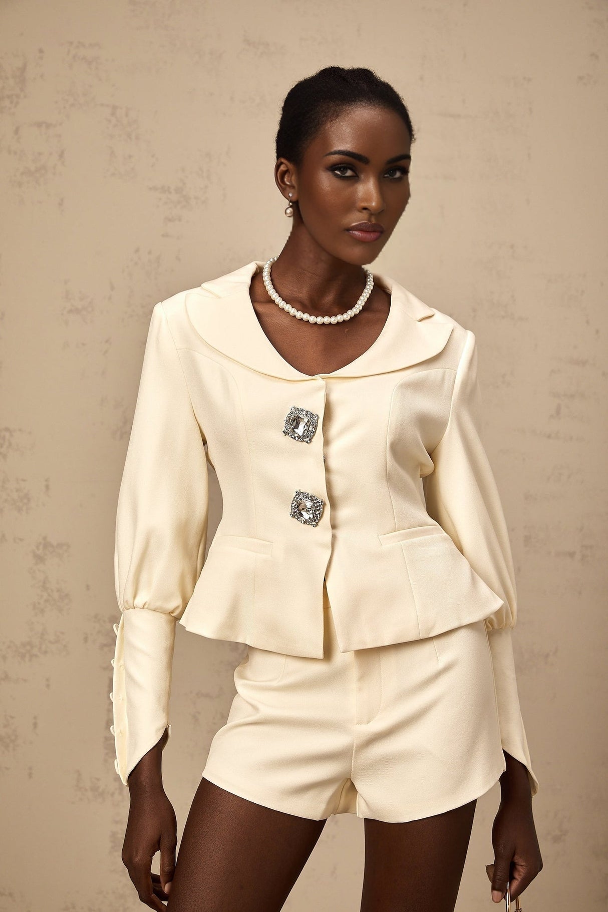 Woman wearing a matching crystalembellished jacket and shorts set in Iselin style