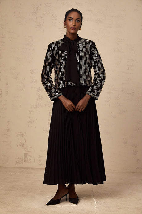 Woman wearing a matching sequined cardigan and dress set in a checkered pattern