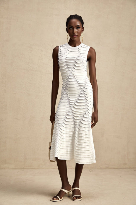 Woman wearing a midi length dress with snake pattern print and godet skirt detail