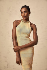 Woman wearing a shimmering sequined midi dress with ribbed knit texture in a fitted silhouette