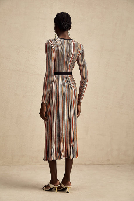 Woman wearing a striped metallic midi dress with a wrap design featuring Adele style
