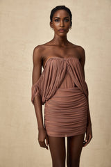 Woman wearing an offshoulder bodysuit paired with a matching skirt in a coordinated Zohra set